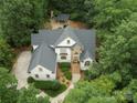 Stunning aerial view of the home showcasing its architectural design, lush landscaping, and outdoor fireplace at 1025 Seminole Dr, Waxhaw, NC 28173