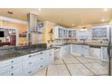 Well-appointed kitchen with white cabinets, granite countertops, stainless steel appliances, and tiled flooring accents at 108 Outside Loop Ln, Mooresville, NC 28117
