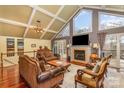 Spacious living room boasts a vaulted ceiling, fireplace, and abundant natural light from large windows and glass doors at 108 Outside Loop Ln, Mooresville, NC 28117