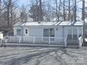 Charming single-story home featuring a metal roof, inviting front porch, and well-maintained gravel landscaping at 110 Shawnee Trl, Mount Gilead, NC 27306