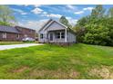 Inviting home with lush green lawn, gray siding, and well-maintained landscaping at 117 Lippard St, Statesville, NC 28677