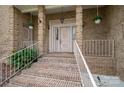 Welcoming brick front porch with steps and decorative hanging plants at 1816 Country Garden Dr, Shelby, NC 28150