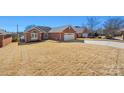 Beautiful brick home with a two-car garage and a spacious, well-kept front lawn at 1911 Connemara Ct, Gastonia, NC 28054
