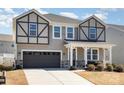 Charming two-story home with neutral siding, black trim, covered porch, and a well-maintained lawn at 19113 Hawk Haven Ln, Charlotte, NC 28278