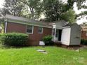 Exterior view of home's rear showcasing brick, vinyl siding and backyard at 2508 Druid Hills Way, Charlotte, NC 28206
