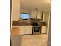 Bright kitchen featuring white cabinets, stainless steel appliances, and tile backsplash at 2508 Druid Hills Way, Charlotte, NC 28206