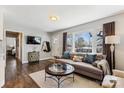 Bright living room featuring hardwood floors, a large window, and a comfortable sofa with stylish pillows at 2727 Hilliard Dr, Charlotte, NC 28205
