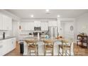 Bright kitchen with white cabinetry, stainless steel appliances, and a large center island with seating at 3878 Fairlady Ln, Fort Mill, SC 29707