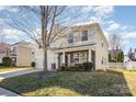 Attractive home with stone and siding, front porch, and manicured lawn in a desirable neighborhood at 4214 High Shoals Dr, Monroe, NC 28110