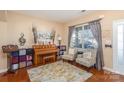 Cozy living room features hardwood floors, a bright window, and comfortable seating at 4214 High Shoals Dr, Monroe, NC 28110