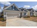 Charming home with blue and beige siding, stone accents, with a two-car garage and driveway at 4246 Millstream Rd, Denver, NC 28037