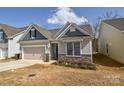 Charming home with blue and beige siding, stone accents, and an attached two-car garage at 4246 Millstream Rd, Denver, NC 28037