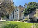 Charming two-story tan home with white trim and lush green lawn on a sunny day at 4825 1St Street Nw Ct, Hickory, NC 28601
