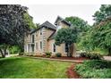 Side view of a two-story home with manicured lawn and mature landscaping at 4825 1St Street Nw Ct, Hickory, NC 28601