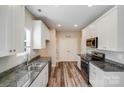 Well-lit kitchen with granite countertops, stainless steel appliances, and hardwood flooring at 509 Holly St, Statesville, NC 28677