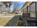 View of the front porch with brick accents and a black iron railing at 629 Johns Ln, Gastonia, NC 28052