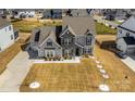 Expansive view showcasing home's exterior, three car garage, and generous lot at 7133 Sumters Camp Trl, Fort Mill, SC 29707