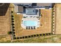 Aerial image of a backyard featuring a modern pool, lounge area, and lush landscaping at 7133 Sumters Camp Trl, Fort Mill, SC 29707