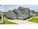 Side view of the home with a spacious three-car garage and well-maintained landscaping at 7133 Sumters Camp Trl, Fort Mill, SC 29707