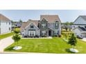 Beautifully landscaped home with a lush green lawn, a long driveway, and mature trees at 7133 Sumters Camp Trl, Fort Mill, SC 29707