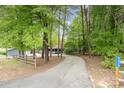 Long driveway leading to a home surrounded by lush trees at 8850 Hills Dell Dr, Concord, NC 28027