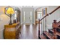 Inviting foyer featuring hardwood floors, arched doorways, staircase, and a stylish console table at 9433 Wallace Pond Dr, Huntersville, NC 28078
