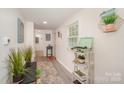Bright hallway with decor, laminate flooring, and ample natural light streaming through a window at 9937 Harwood Ln, Charlotte, NC 28214