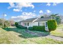 White single-story house with manicured lawn and paved walkway to the front door at 1022 Kannapolis Pkwy, Concord, NC 28027