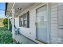 Inviting front porch with a chair, screen door, and view of a manicured landscape at 1022 Kannapolis Pkwy, Concord, NC 28027