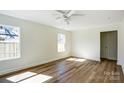 A bright bedroom featuring hardwood floors, fresh white paint and natural light at 1045 Gaither Nw Pl, Concord, NC 28027