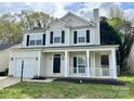 Two-story home with black shutters, front porch and a well maintained lawn at 12044 Brownestone View Dr, Charlotte, NC 28269