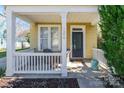 Inviting front porch with seating area, white railings, and view of the front door at 1246 Rising Oak Dr, Charlotte, NC 28206