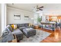 Comfortable living room with a large gray sectional, hardwood floors, and stylish decor at 1246 Rising Oak Dr, Charlotte, NC 28206