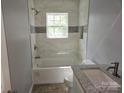Well-lit bathroom featuring modern tile surround, updated fixtures, and a convenient built-in niche at 126 Lowry St, Chester, SC 29706