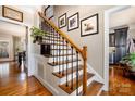 Stylish staircase featuring wood treads, black wrought iron spindles, and decorative wall art at 1263 Crooked Stick Dr, Rock Hill, SC 29730