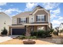 Charming two-story home featuring a brick and siding exterior, attached garage and manicured landscaping at 15131 Oleander Dr, Charlotte, NC 28278