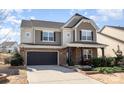 Beautiful two-story home with stone accents, black two-car garage, and professionally landscaped front yard at 15131 Oleander Dr, Charlotte, NC 28278