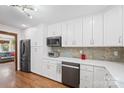 Well-lit kitchen features a black stainless refrigerator, custom cabinets, and backsplash at 1755 Simplicity Rd, Concord, NC 28025