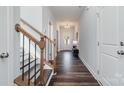 Inviting hallway with hardwood floors, a staircase, and ample natural light streaming through the front door at 1809 Country Club Rd, Lincolnton, NC 10757