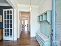 Bright entryway with hardwood floors, coat rack, and white trim welcomes you home at 1905 Summey Ave, Charlotte, NC 28205