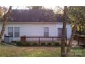 Rear exterior view showcasing a cozy wooden deck and a serene outdoor space perfect for relaxation at 2032 David Earl Dr, Charlotte, NC 28213