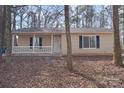 Single-story home featuring vinyl siding, a welcoming front porch, and classic design in a peaceful, wooded setting at 207 American Dr, Salisbury, NC 28147