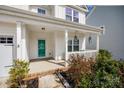 Inviting front porch with a vibrant teal door and stylish hanging lanterns at 2076 Brightflower Ln, York, SC 29745