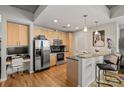 Well-lit kitchen with stainless steel appliances, breakfast bar, and adjacent workspace at 210 N Church St # 1413, Charlotte, NC 28202