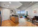 Open-concept living space with hardwood floors, concrete ceilings, and a stunning city view at 210 N Church St # 1413, Charlotte, NC 28202