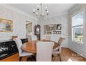 Elegant dining room with chandelier, wallpaper, and a wooden table with upholstered chairs at 3013 Arsdale Rd, Waxhaw, NC 28173