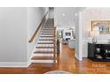 Inviting foyer with hardwood floors, staircase, and a glimpse into the living room at 3013 Arsdale Rd, Waxhaw, NC 28173