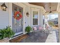 Inviting front porch featuring a cozy seating area, decorative wreath, and a 'Welcome' mat at 3013 Arsdale Rd, Waxhaw, NC 28173