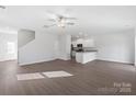 Inviting living room with wood floors, ceiling fan, and an open floor plan with lots of natural light at 3418 Saddlebred Dr, Gastonia, NC 28052