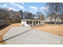 Corner lot showcasing new home, long drive, manicured front yard, and inviting front porch at 407 S Spargo St, Dallas, NC 28034